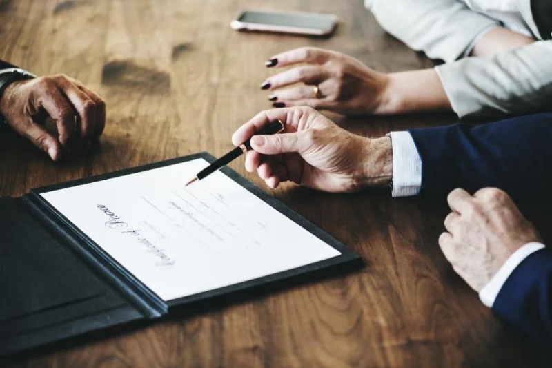 close up of a man preparing to sign the divorce certificate 1